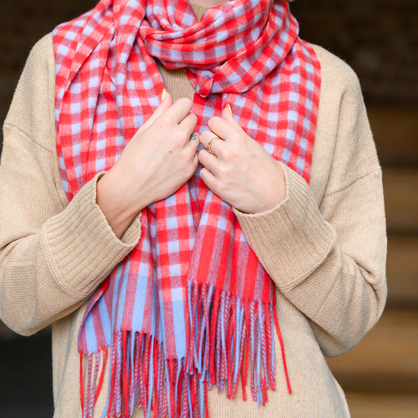 Woman wearing red gingham lambswool scarf